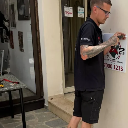Engineer installing security signage b